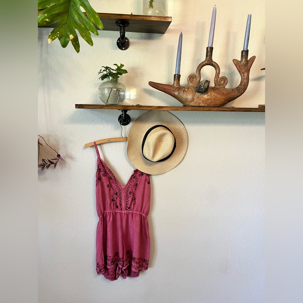Dusty rose, embroidered romper. Adjustable straps and an elastic waist.